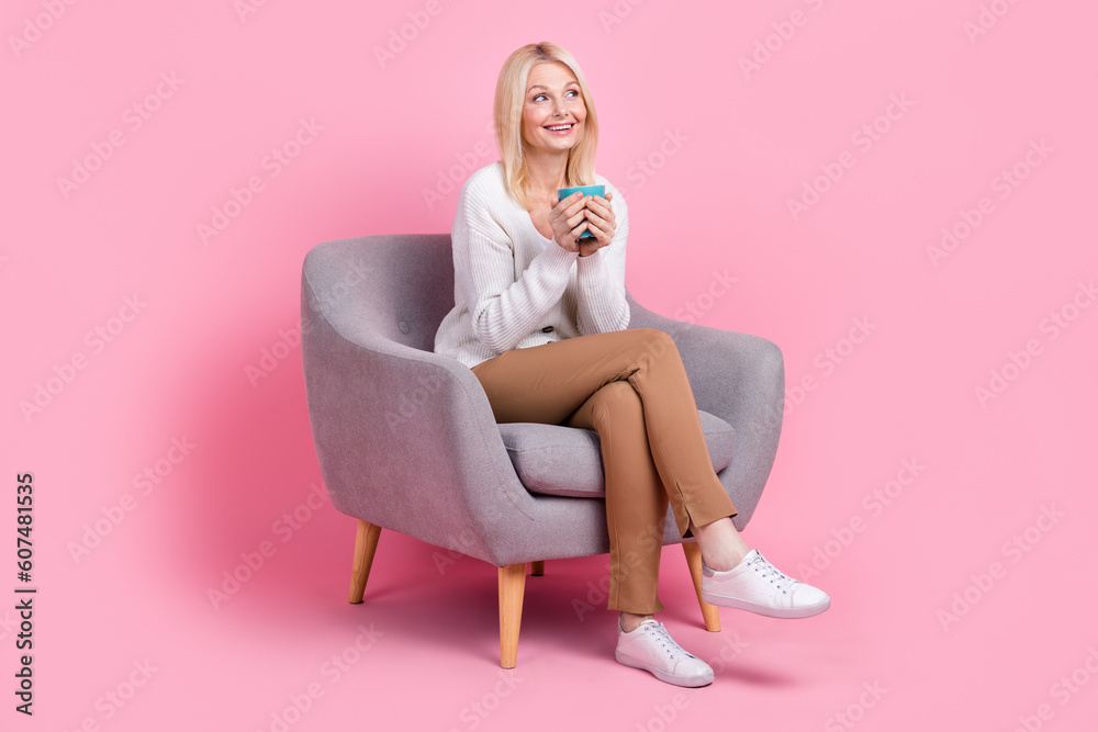 Canvas Prints Full body portrait of peaceful minded person sit chair hold coffee cup look empty space isolated on pink color background