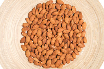 Almonds nuts in a wooden plate.