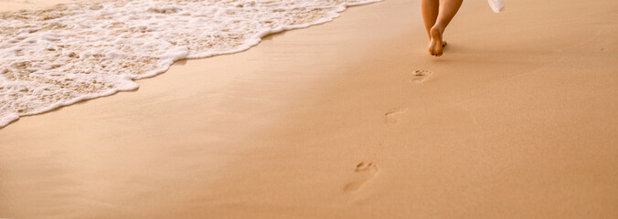 woman's footsteps on the beach 