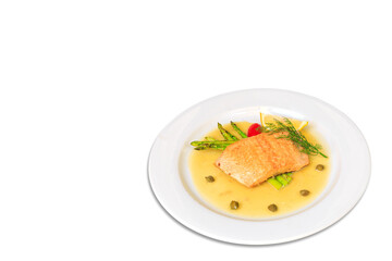 Salmon steak on the grill with asparagus  and herbs on white plate