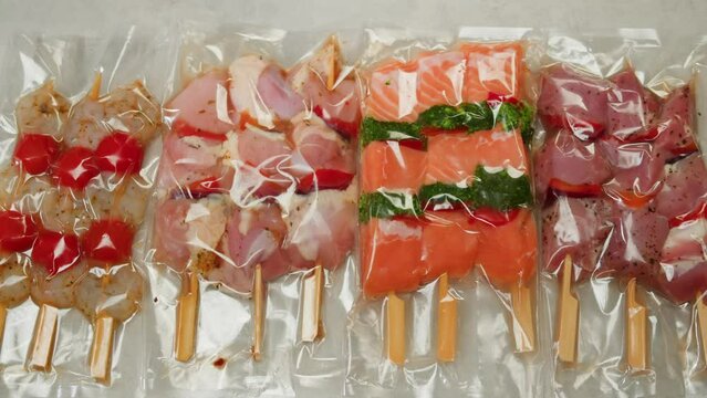 Beef, chicken and salmon tapas skewer in vacuum plastic bag ready for sous vide cooking or grill, supermarket ready to eat food.