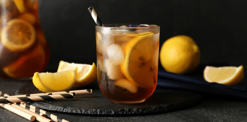 Glass of tasty Long Island iced tea on dark background