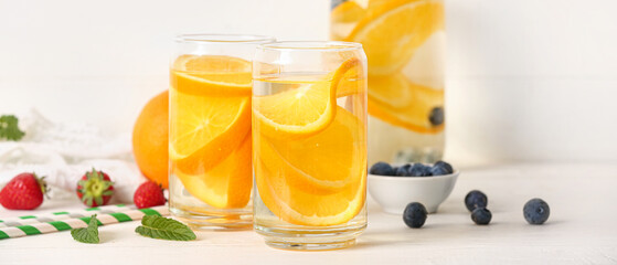 Glasses of orange infused water on table