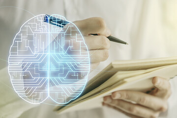Double exposure of creative human brain microcircuit with man hand writing in notepad on background. Future technology and AI concept