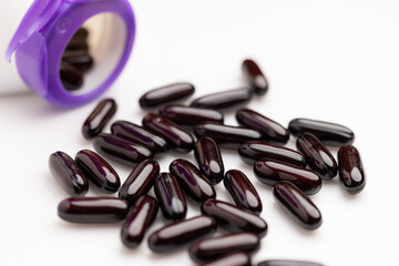 Vitamin liquid capsule from bottle