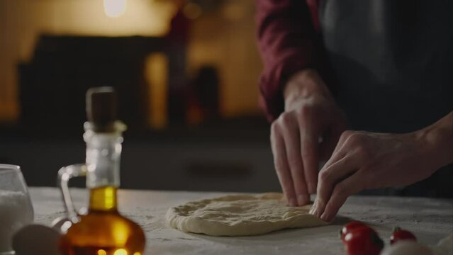 Margherita, Chef in action Preparing pizza Strongly From dough Shapes creates a round shape pizza in a takeaway restaurant Junior specialist Bakes a Neapolitan pizza in fast food restaurant Neapolitan