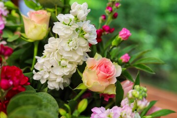 A bouquet of flowers with tea roses, carnations, dianthus caryophyllus, Delphinium, floristic composition.