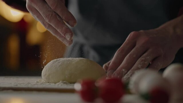 Margherita, Chef in action preparing a pizza working with dough adding flour in a takeaway restaurant In slow motion Junior specialist Baking Neapolitan pizza in a fast food restaurant, Neapolitan

