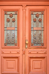 Fototapeta na wymiar View of ornate wooden door in city, closeup
