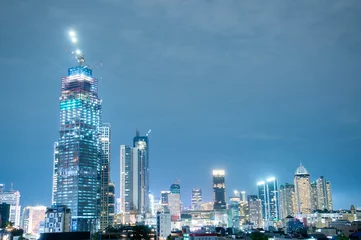 Papier peint photo Séoul Jakarta's urban cityscape in the night time, so many buildings yet the constroction keeps developing  © Arief Baskoro