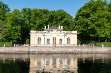 A mansion in a summer garden on the banks of the river