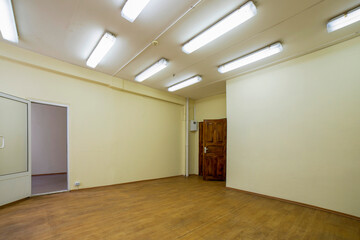 A fragment of the interior of an empty room with an open door