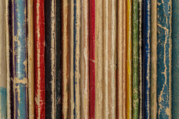 spines of several old shabby books
