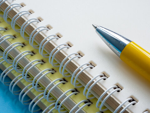 The pen lies on a stack of notebooks as a concept of education.