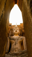 Giant statue of seated Buddha in mara mudra position, enveloped in an atmosphere of silence and...