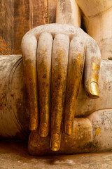 Giant statue of seated Buddha in mara mudra position, enveloped in an atmosphere of silence and...