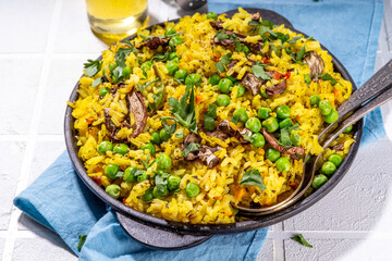 Homemade vegetarian pilaf with vegetables, green pea and champignon mushrooms 