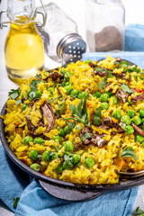 Homemade vegetarian pilaf with vegetables, green pea and champignon mushrooms 