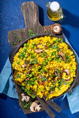 Homemade vegetarian pilaf with vegetables, green pea and champignon mushrooms 