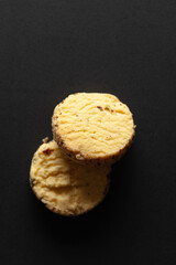 Two whole wheat chip cookies on black background. Top-down view. Food Flat lay.