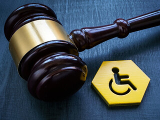 Gavel as symbol of law and disability person sign.