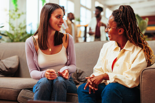 Multiracial young women having conversation.