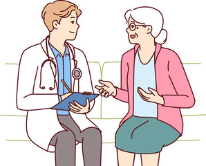 Obraz premium Elderly woman with doctor sit on couch complaining to hospital employee about health problems