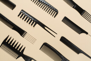 Professional combs and hairdresser tools on color background, top view