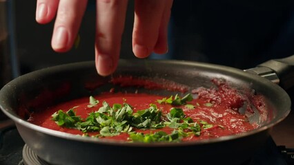 Cooking tomato sauce classic homemade Italian tomato sauce with basil for pasta and pizza in the pan. Chef cooking traditional Italian food.