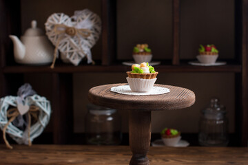 Sweet dessert on display in vintage style on a wooden stand. Rustic pastry shop style