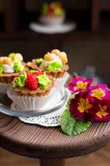 Sweet dessert on display in vintage style on a wooden stand. Rustic pastry shop style