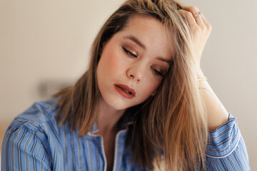 Fototapeta premium Portrait of young woman in blue pajama.