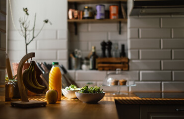 Close up of kitchen with salad and juice.