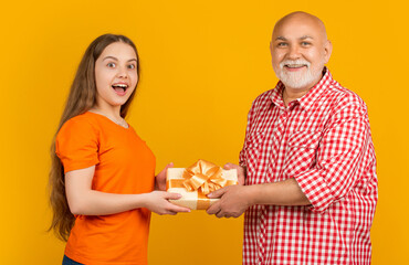 amazed kid and granddad with present box for anniversary