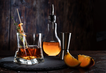 A glass of whiskey and bartending accessories. Bar still life.