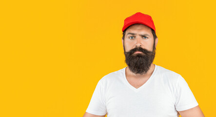 bearded deliveryman on background with copy space. photo of bearded deliveryman with cap