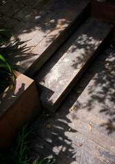 Composition of wooden front house steps with shadow of leaves through the sunlight