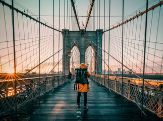silhouette of a tourist on the  Brooklyn Bridge in New York city