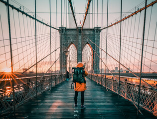 silhouette of a tourist on the  Brooklyn Bridge in New York city