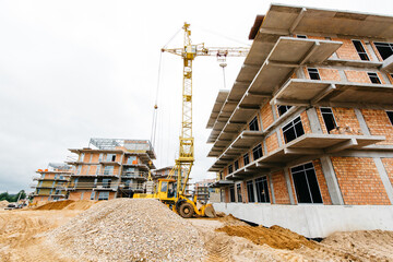 Crane and building under construction against blue sky