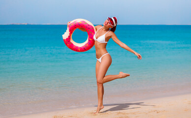 Model tourist woman in bikini on Jumeirah beach, Dubai, UAE