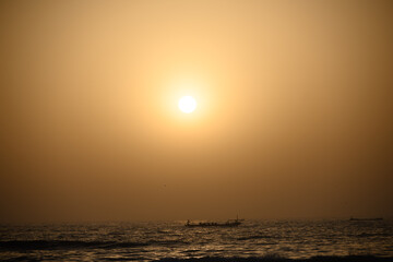 Fototapeta na wymiar Sunset on the Senegalese Sea with boats