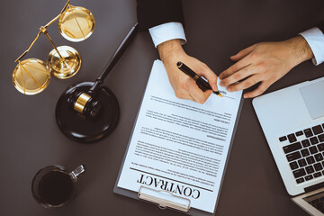 Top view lawyer signing contract, professional lawyer in law firm office drafting legal document or...