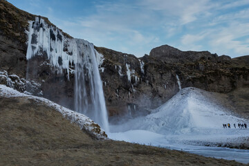 Iceland waterfall in winter with ice and snow