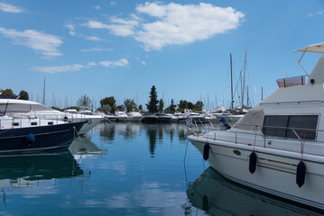Luxury modern yachts with reflection in calm water in Greece. Vacation and tourism concept 