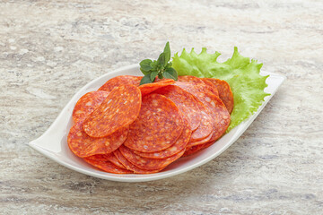 Sliced pepperoni sausage in the bowl