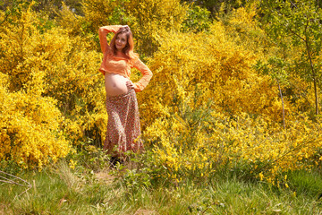 Young pregnant woman touching and looking at her belly and caring about her health.Pregnancy, maternity, preparation and expectation concept.Beautiful tender mood of pregnant woman.Young mom.      