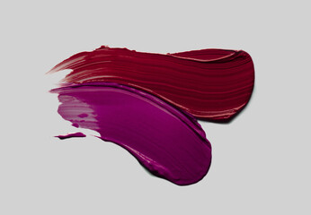 Lipstick lip gloss or balm cherry red colored abstract strokes smudge  background texture gray...
