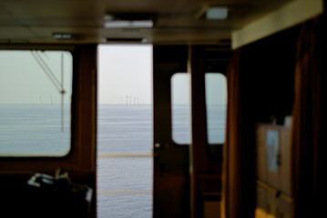 Morning view before the sunrise at sea with wind generators in the background. Wheelhouse view. © I am from Mykolayiv
