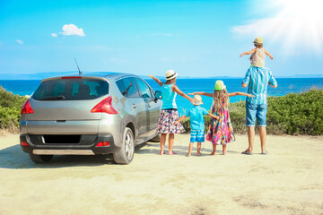A happy family by car by the sea in nature weekend travel